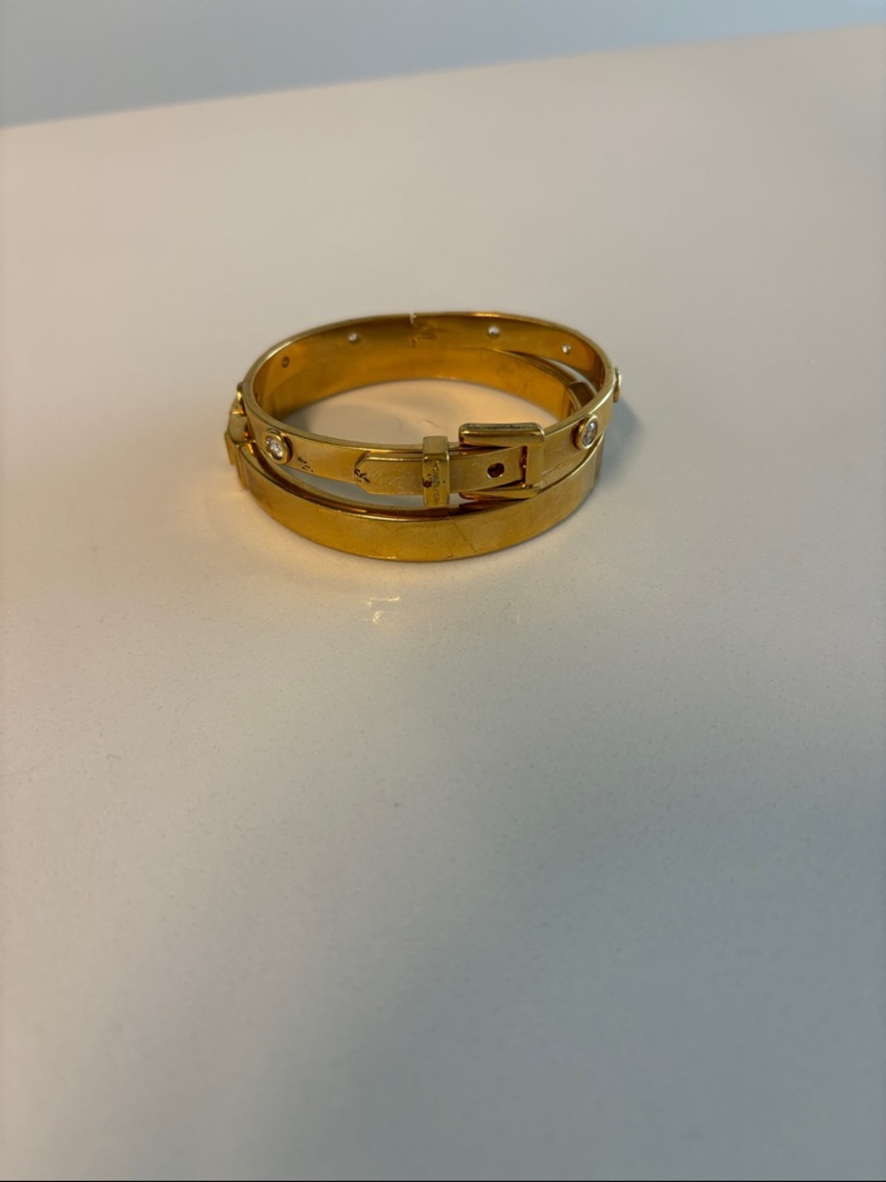 Two Gold-Tone Buckle Bangle Bracelets